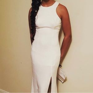 White dress with gold sparkles with a slit.